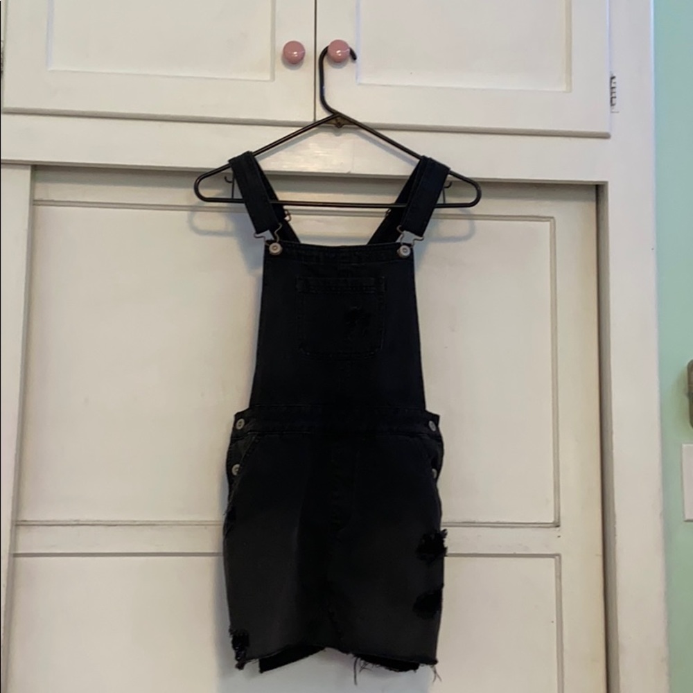 black ripped overall dress with flower patch